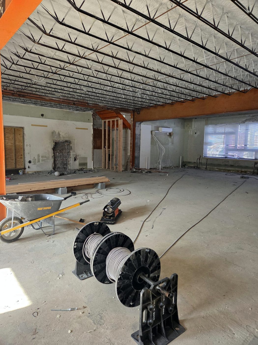Cable reel and tools in a commercial space under renovation