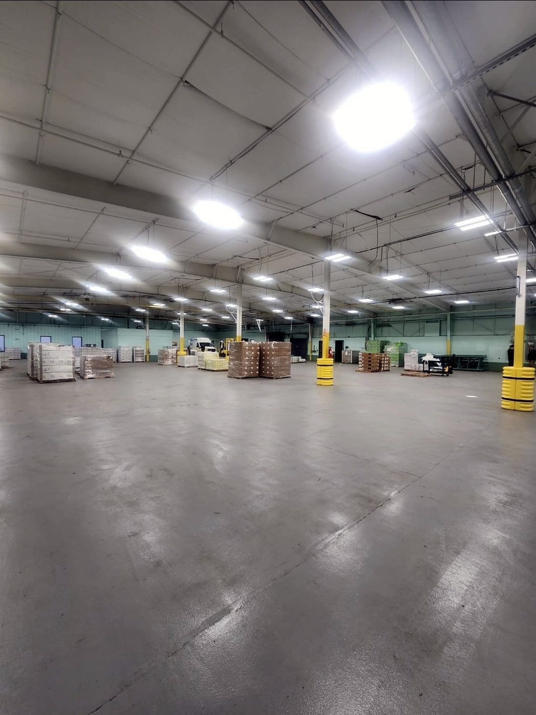 Large warehouse interior with high bay lighting and pallets
